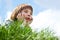 Cute little boy laying on green grass over blue sky spring natur