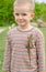 Cute little boy with a live lizard on his shirt