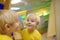 Cute little boy looks in distorting mirror in playcenter