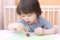 Cute little boy made toothpick spines by playdough hedgehog