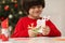 Cute little boy making paper angel for Saint Nicholas day at home, focus on hands