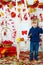 Cute little boy painting apples in autumn