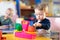 Cute little boy playing with abacus in nursery. Preschooler having fun with educational toy in daycare or creche. Smart