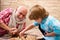 Cute little boy playing chess. Childhood. Cute little boy playing chess. Generations. Handsome grandpa and grandson are