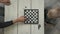 Cute little boy playing chess at home.