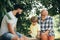 Cute little boy playing chess with Parents. Three different generations ages: grandfather father and son together.