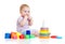 Cute little boy playing colorful toys