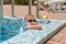 Cute little boy playing at the edge of a pool