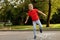 Cute little boy playing hopscotch outdoor. Street children`s games. Selective focus