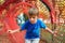 Cute little boy playing outdoors. Child having fun in tunnel at the modern playground. Happy childhood. Summer holidays