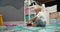 Cute little boy playing with toy firetruck in child bedroom in home