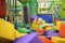 Cute little boy plays with soft cubes in the dry pool in play center. Kid playing on indoor playground in foam rubber pit in