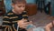 Cute little boy putting doughnut to plastic box