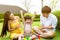 Cute little boy raise hands up and get happiness that kid can finish homework. Mother and father give son a big hand for