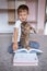 Cute little boy reading a book with a cat. Home schooling. Distance learning. Holidays. Quarantine during the Coronavirus pandemic