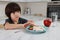 Cute little boy refusing to eat dinner in kitchen