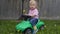 Cute little boy riding a green machine