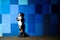 Cute little boy on roller skates standing against the blue graffiti wall