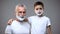 Cute little boy in shaving foam hugging his grandfather, morning ritual