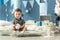 Cute little boy sitting on fluffy rug in room decorated for birthday party
