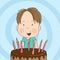 Cute little boy smiling happily, celebrating birthday, b-day chocolate cake with seven candles in front of him