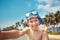 Cute little boy in snorkeling mask making selfie at tropical beach on exotic island