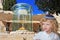 Cute little boy stands at the Golden Menorah