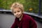 Cute little boy with static electric hair, having his funny portrait taken outdoors on  trampoline