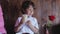 Cute little boy tasting coffee from cup at cafe