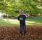 Cute little boy throwing colorful leaves