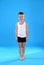 Cute little boy in underwear on light blue background