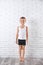 Cute little boy in underwear near white wall