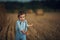 Cute little boy walking among the sheafs - countryside shot