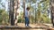 Cute little boy walking on a thin log in the background of the forest. The child develops agility and courage. The