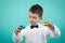 Cute little boy with white shirt and bow tie, playing with cars toy
