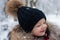 Cute little boy in winter time. Happy toddler boy in the park. Cheerful child playing in the winter park. Happy child