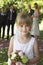 Cute Little Bridesmaid Holding Bouquet In Garden