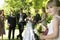 Cute Little Bridesmaid Holding Bouquet In Lawn