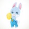 Cute little bunny in denim overalls holds yellow Easter painted egg in paws