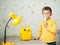 Cute little caucasian boy making inhalation at home using electric medical gear