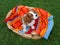 Cute little Cavalier King Charles Spaniel sitting on the colorful blanket in the wooden basket