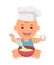 Cute little chef. Toddler in a cook cap with a spoon and an egg in the hands knead the dough.