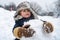 Cute little child boy on snowy field outdoor. Child boy Having Fun in Winter Park. Happy smiling little boy child make