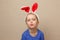 Cute little child girl wearing bunny ears on Easter day.