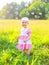 Cute little child on the grass with many soap bubbles