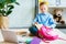 cute little child packing school bag while sitting on carpet