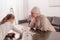 cute little child with sick grandmother in kerchief playing with jigsaw puzzle together