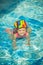 Cute little child swimming in pool