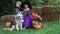 Cute little children and dog with carving pumpkin in garden. Happy family preparing for Halloween. Funny kids at