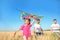 Cute little children with kite in field on sunny day